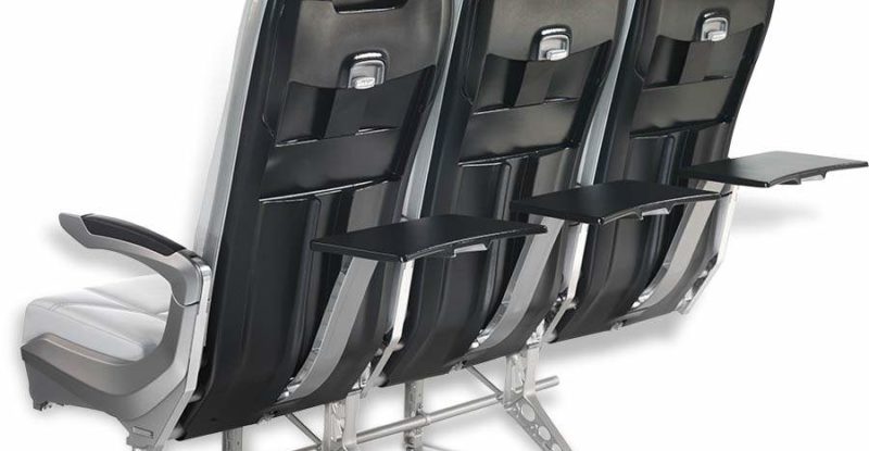 3 slimline aircraft seats view from the back with tray tables opened