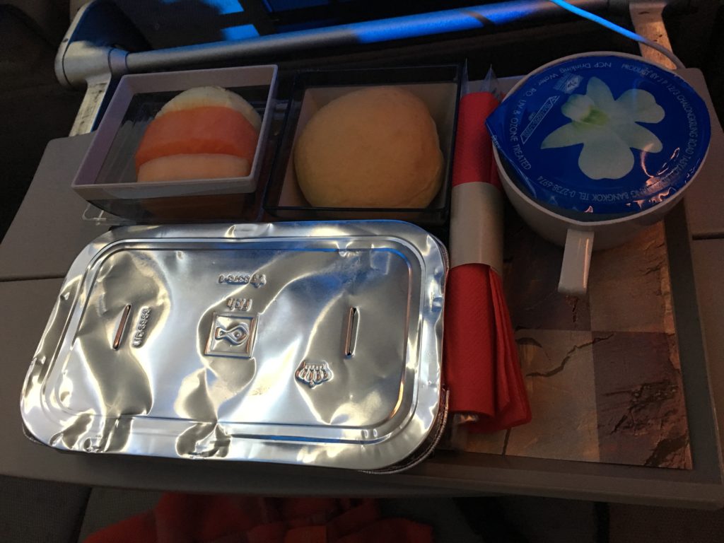 A meal that is served on the Royal Jordanian flight is being displayed on the tray table. 