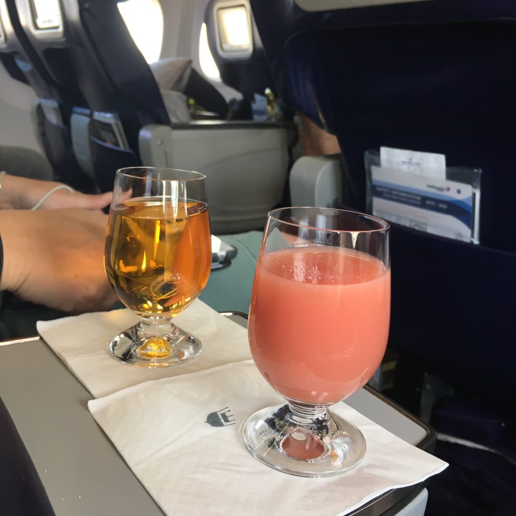 aircraft seat tray with fancy drink displayed on it