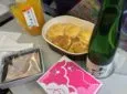 An airline meal tray with bottle of champagne
