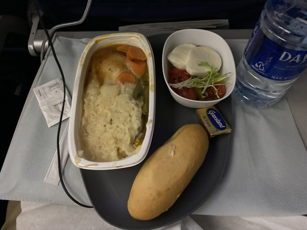 inflight meal bread and entree on tray table