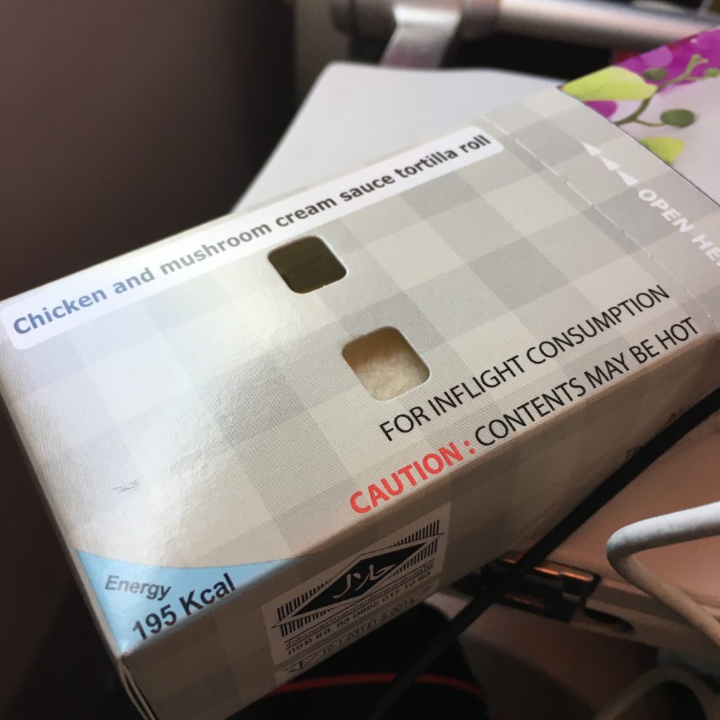 boxed meal on aircraft tray table