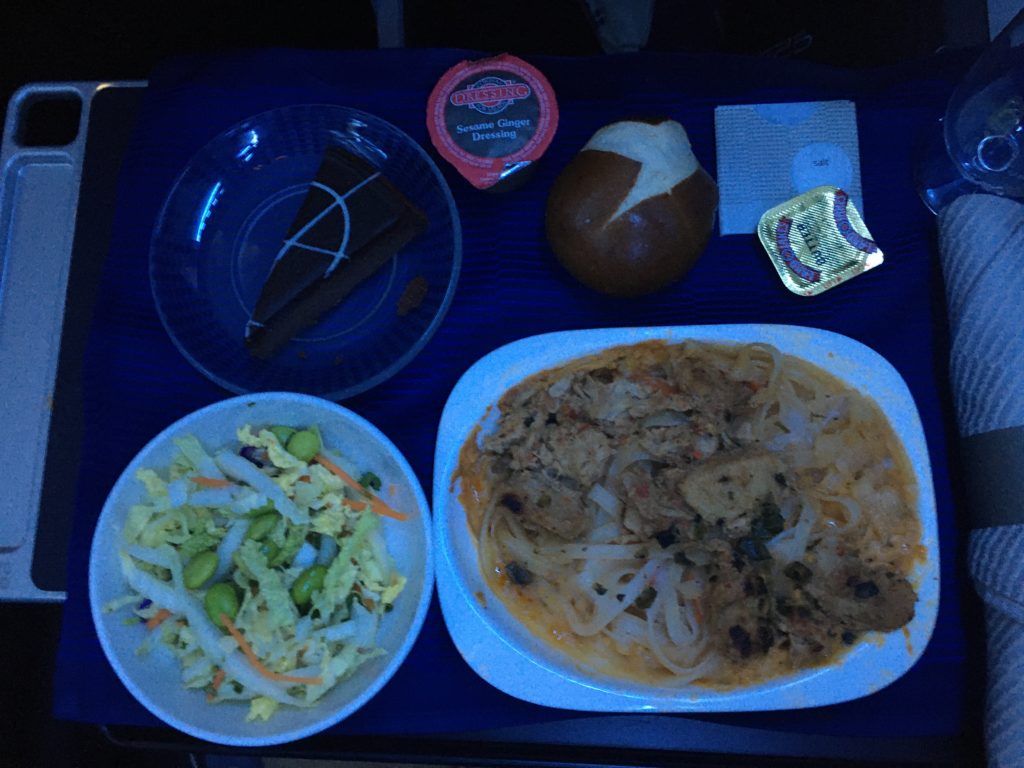 meal service on an aircraft, meal sitting on seat tray table