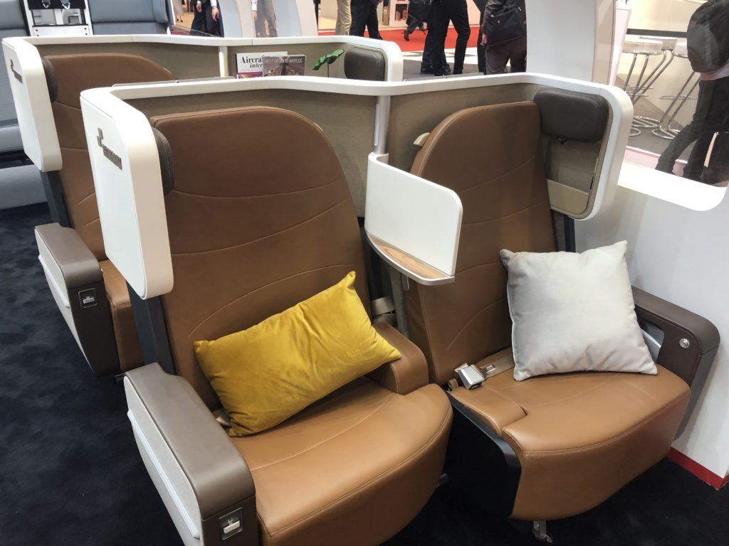 Two business class seats with brown Ultraleather