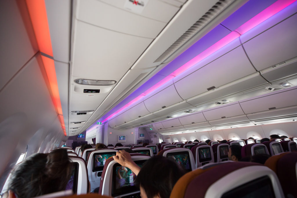 interor of aircraft with led lighting and ife screens in seatbacks