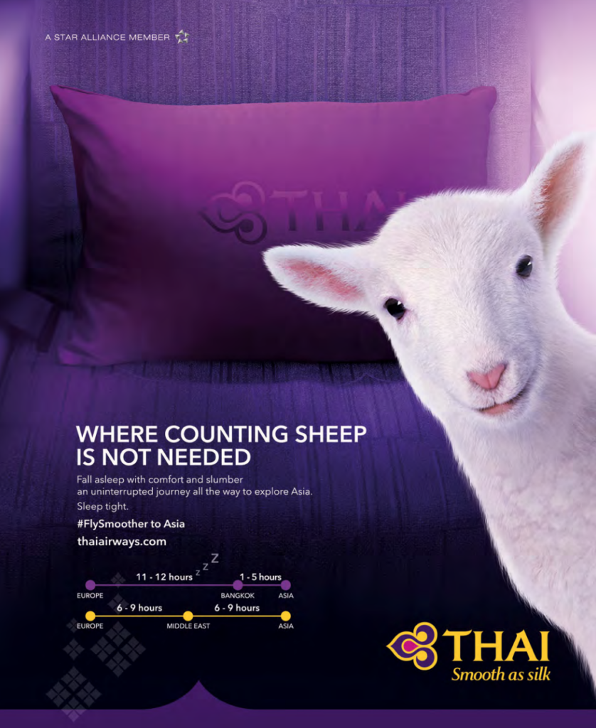 Thai Airways purple pillow on purple aircraft seat with a sheep poking its head out