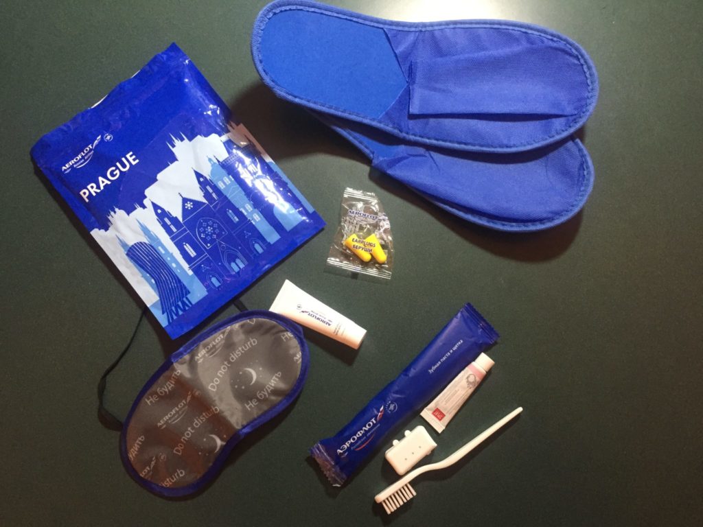 Amenity kit with sleep mask, slippers and tooth brush