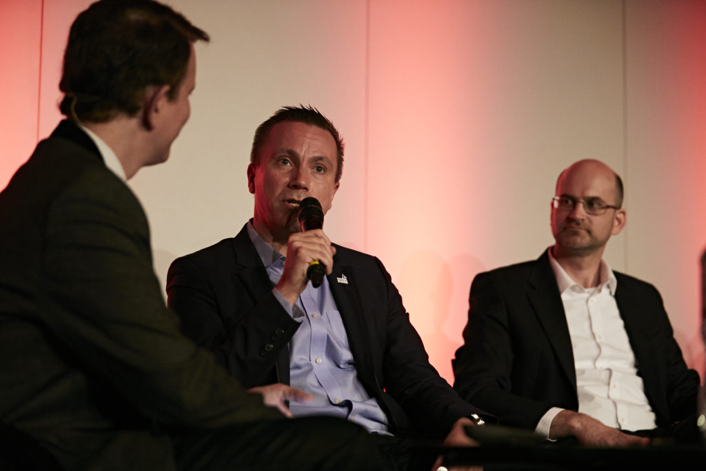 three men sitting having a conversation