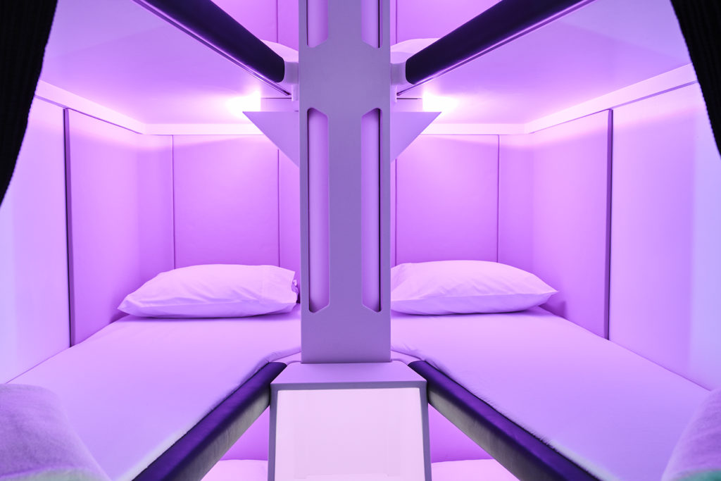 An empty Skynest with pillow, mattress and purple LED lighting