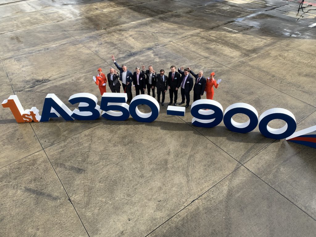 An aerial photo of Aeroflot crew and a big sign saying "1st A350-900"