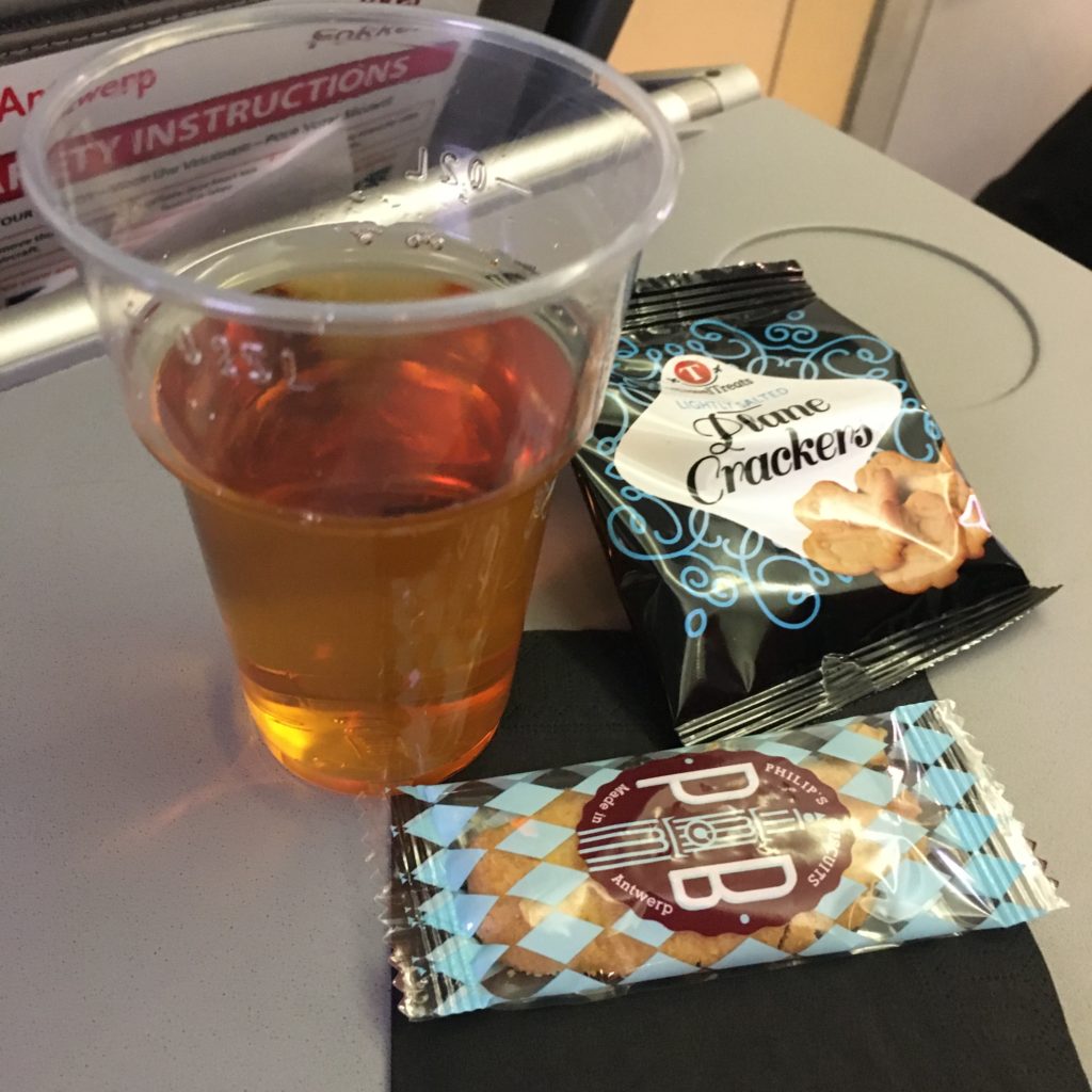 cookie and drink on inflight tray table