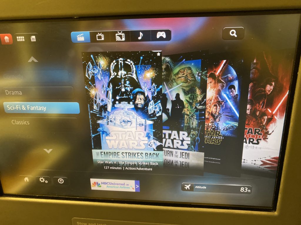 A large IFE screen with a variety of content, including movies from the Star Wars series