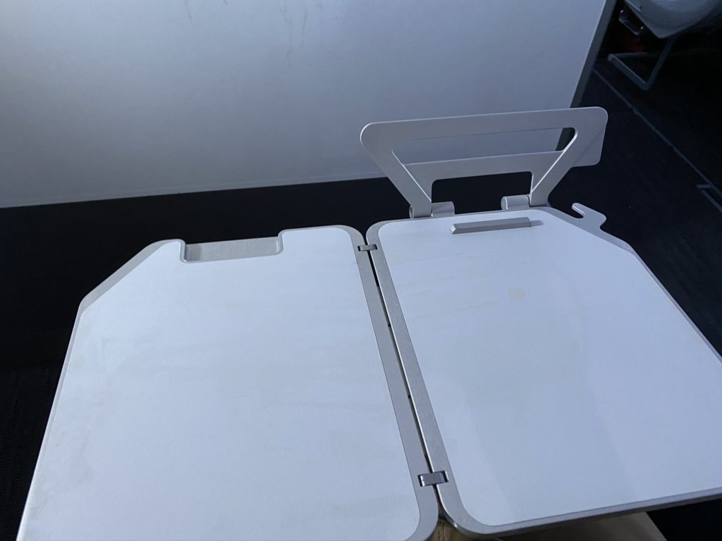 Tray table open and tablet holder displayed empty