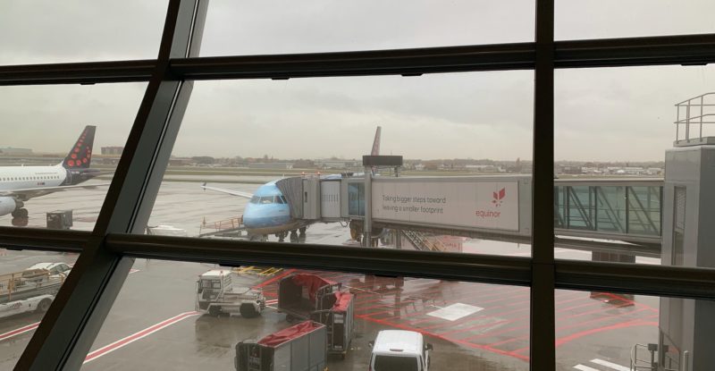 looking out to the jetway bridge from the airport window on a foggy day