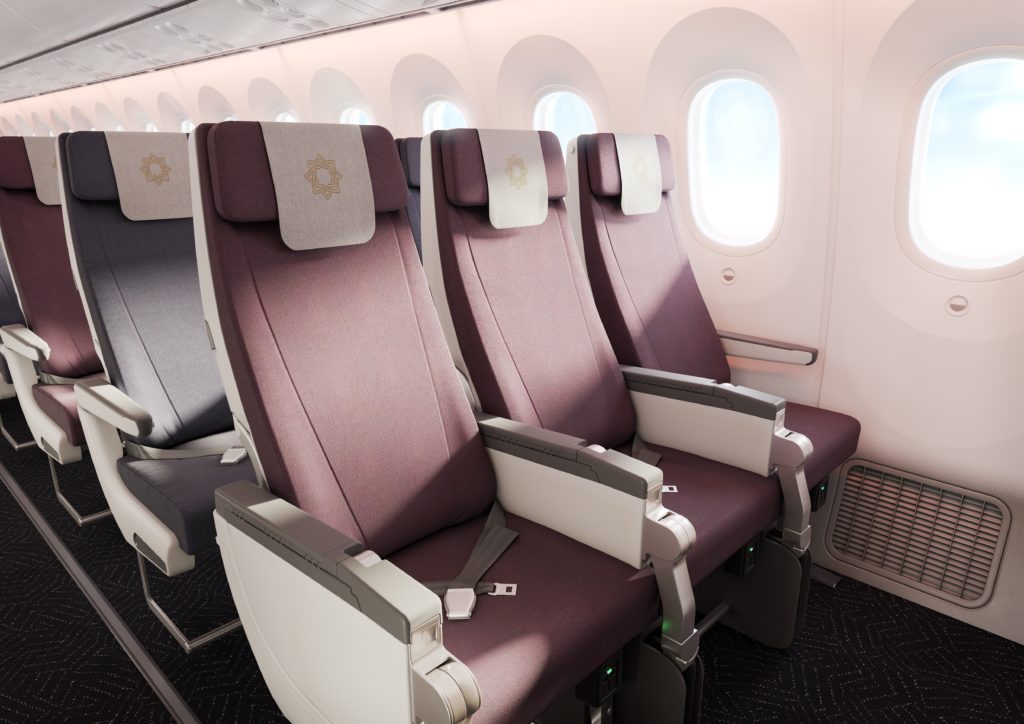 Close up of the economy class seat with red fabric by a open bright window