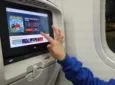 A young girl is using the IFE system on Air Canada