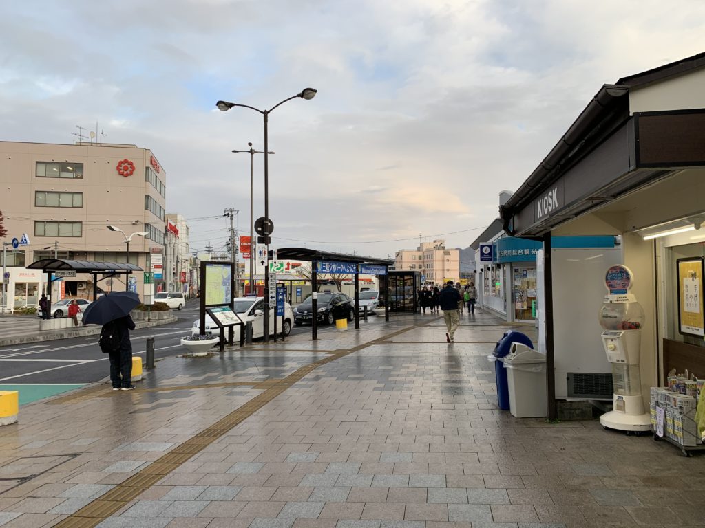 A city scene, with low-level buildings in sight, and pedestrians 