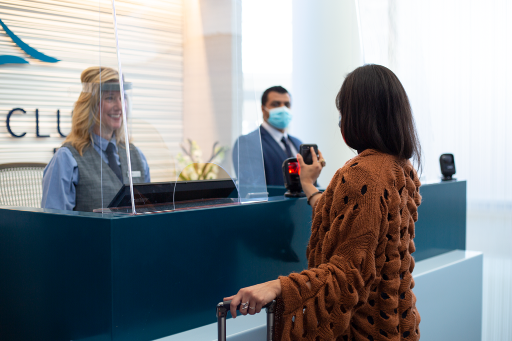 A female traveler access the lounge through touchless entry