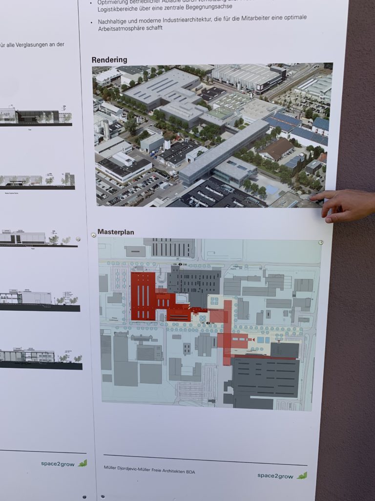 A graphic on cardboard showing the final plan for Recaro's expanded facilities. Buildings are shown in red to represent the red phase