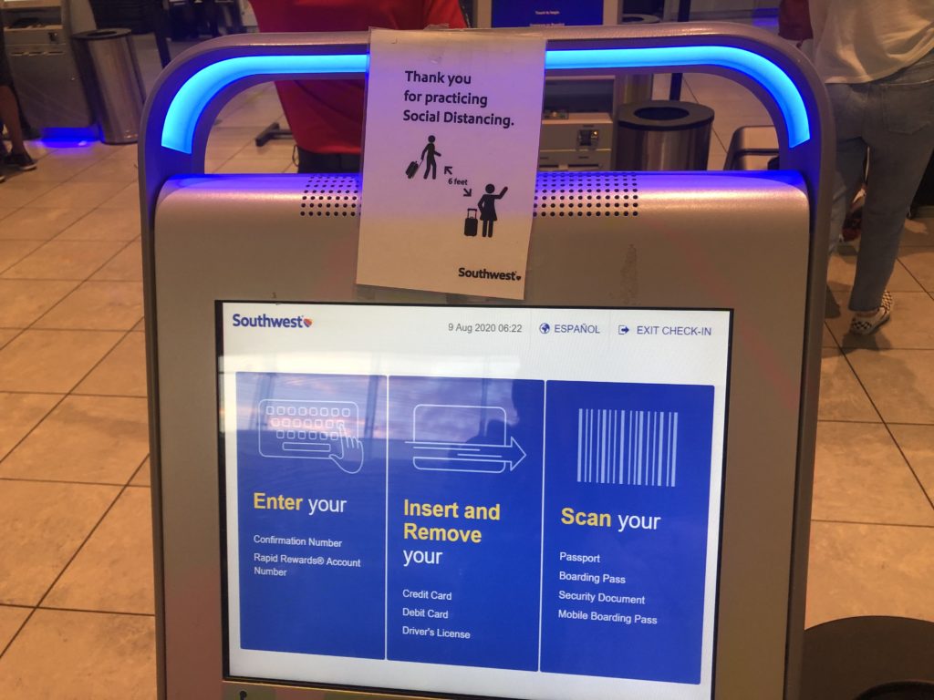 A Southwest check-in kiosk with a sign that says: "Thank you for practicing social distancing"