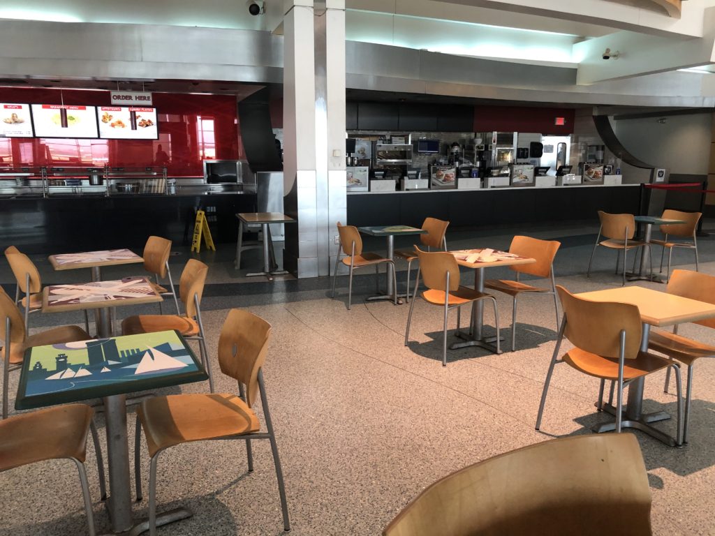 Tables and chairs spaced apart at the food court at BWI