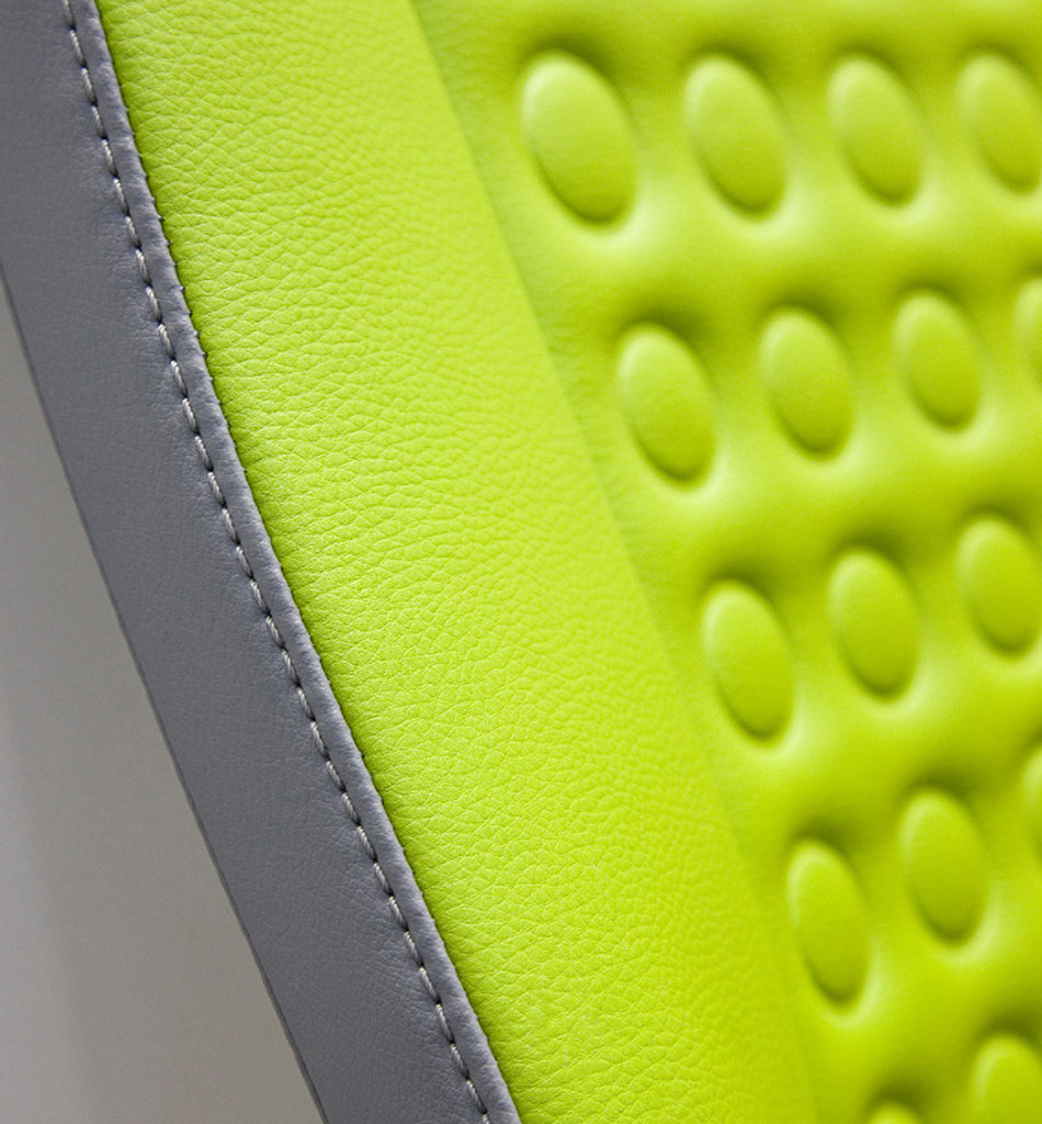 Close up of Eleather grey stitching seat detail with green textile as well.