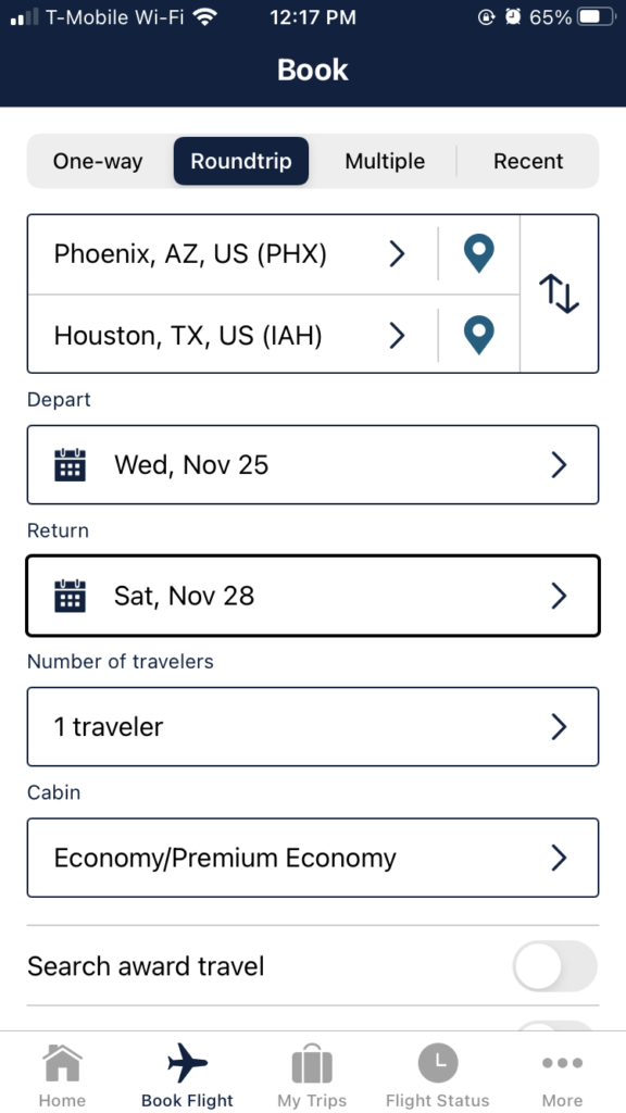 With dark bluish black & white contrast, the "Book Flight" page on the app, which allows the user to plug in their desired city pair, and dates of travel.