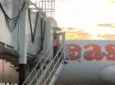 easyJet A320 passenger aircraft at the gate, with the jetway in view