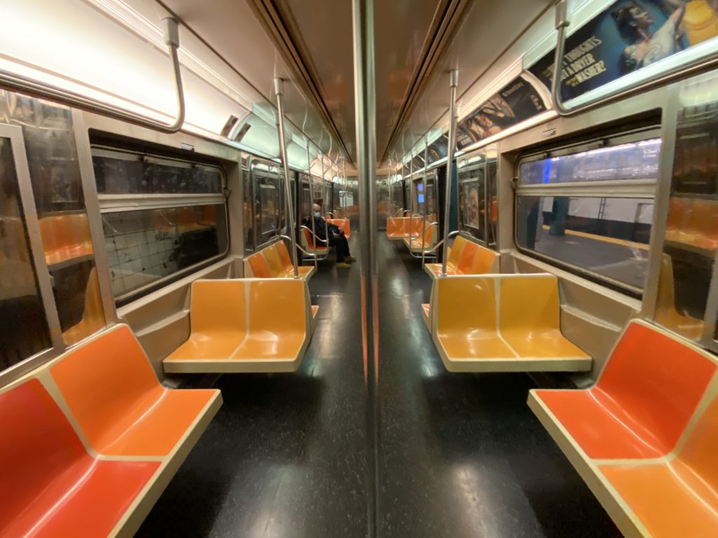 A sparkling clean subway car, with only one passenger