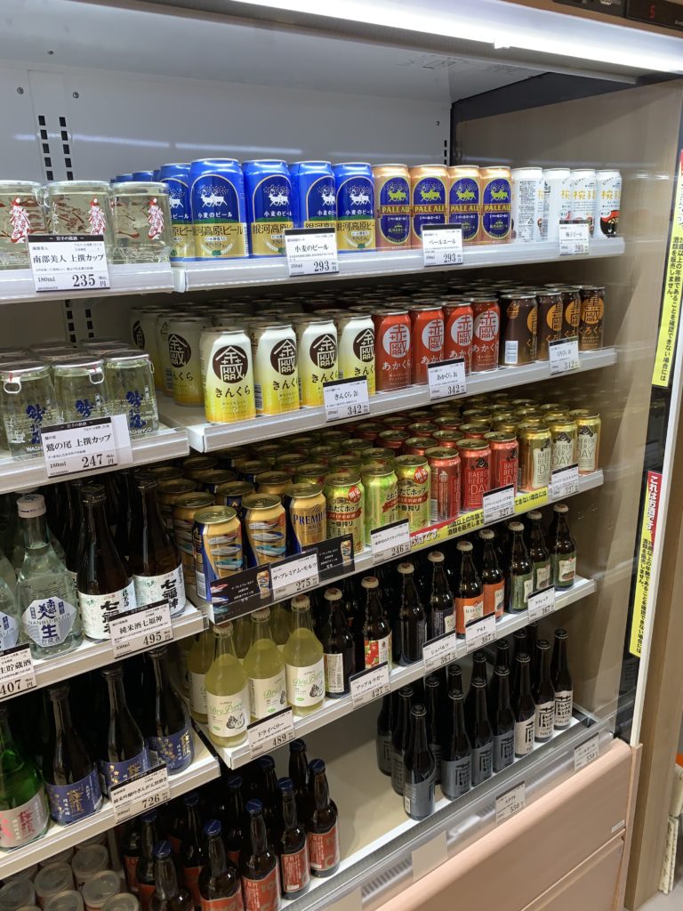 Shelves in a small station store featuring different types of beverages