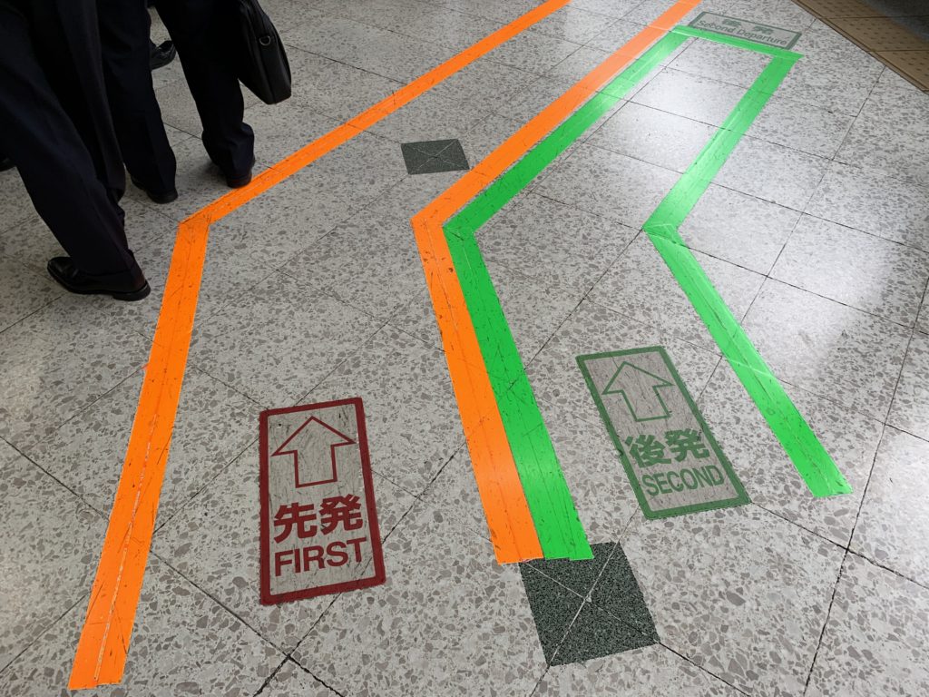 Markings on the floor to direct "first" and "second" class passengers