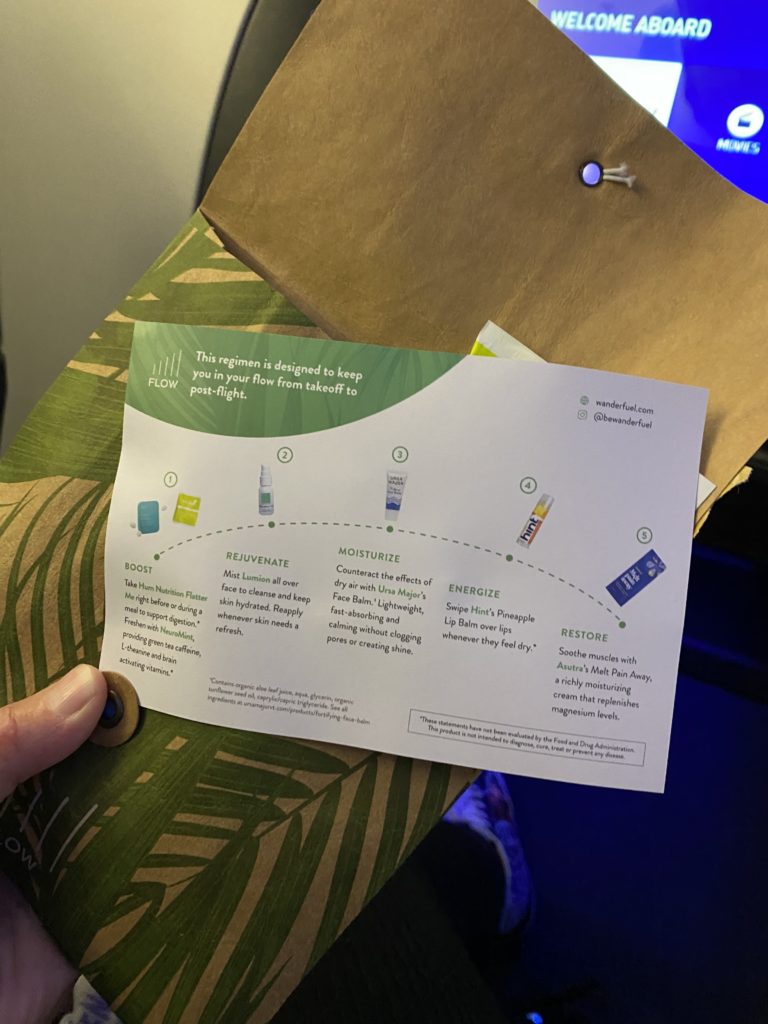 A brochure detailing the contents of the new amenity kit, as held by the author in-flight