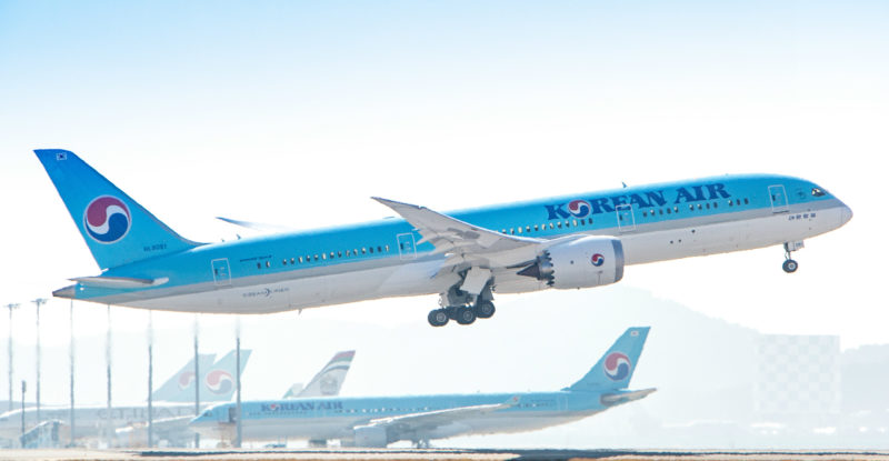 Korean Air Boeing 787-9 taking off with clear blue sky and another aircraft in the background