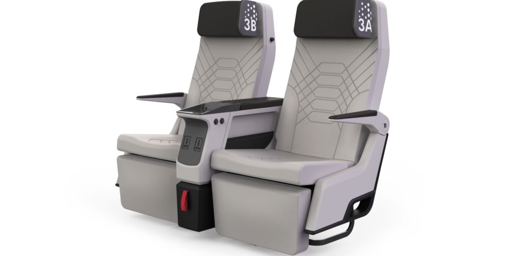 The Aviointeriors Synthesys premium economy seat is picture with black headrests and a light grey seat cover with stitching