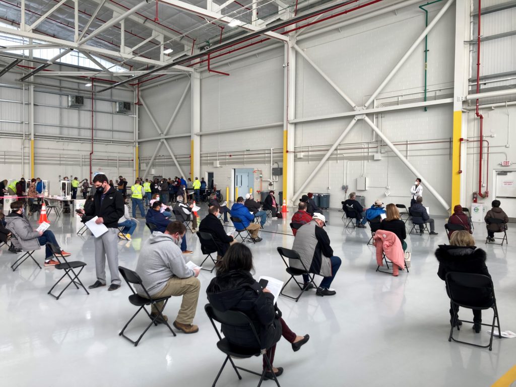 Socially distanced seats, with people waiting for their vaccinate, at DuPage Airport