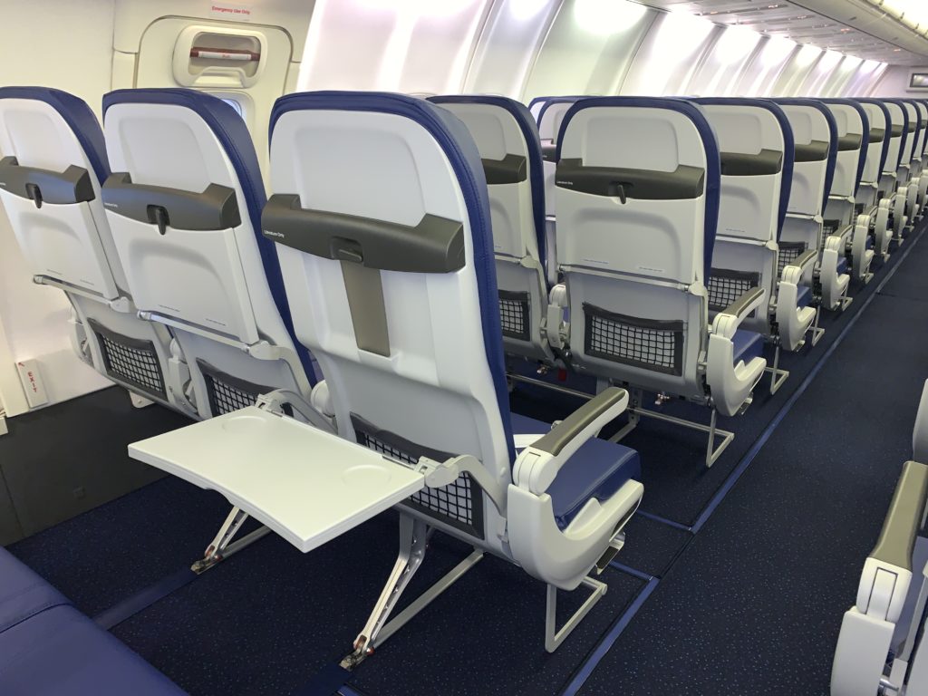 Rows of slimline seats in an aircraft cabin with thermoplastic seatbacks