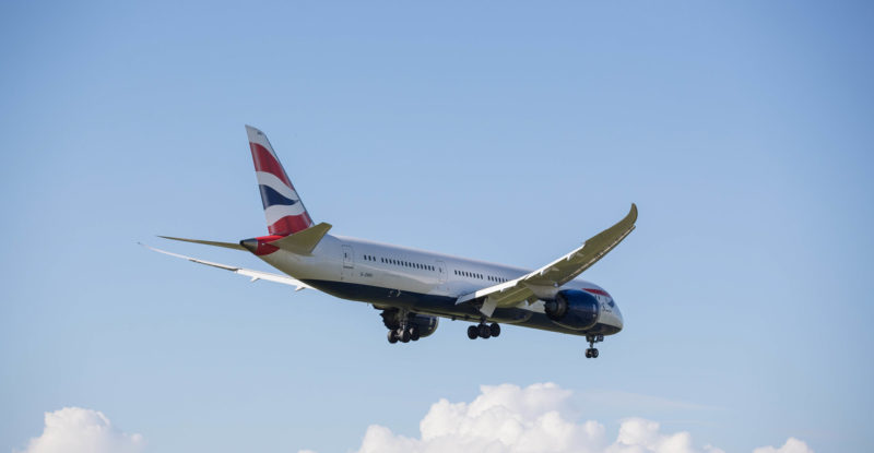 British Airways 787 with landing gear out in a clear blue sky