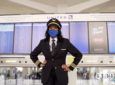Carole Hopson in uniform, masked, at the United gate.