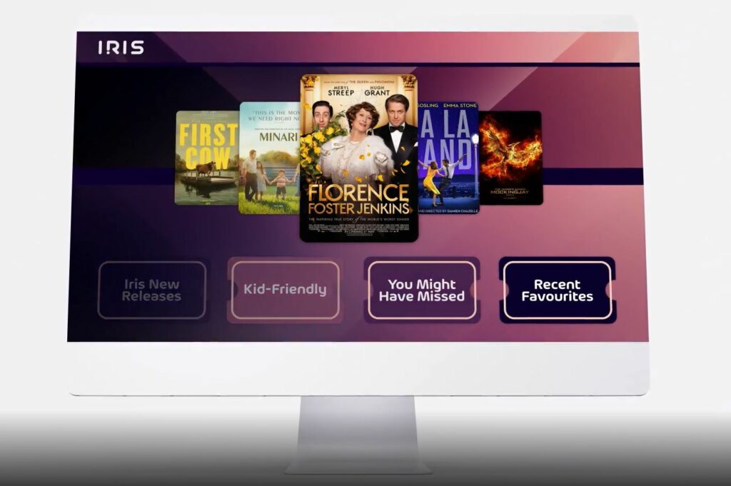 A screen showing different movie selections offered with the Iris platform. The backdrop is a variety of pinks/purples. 