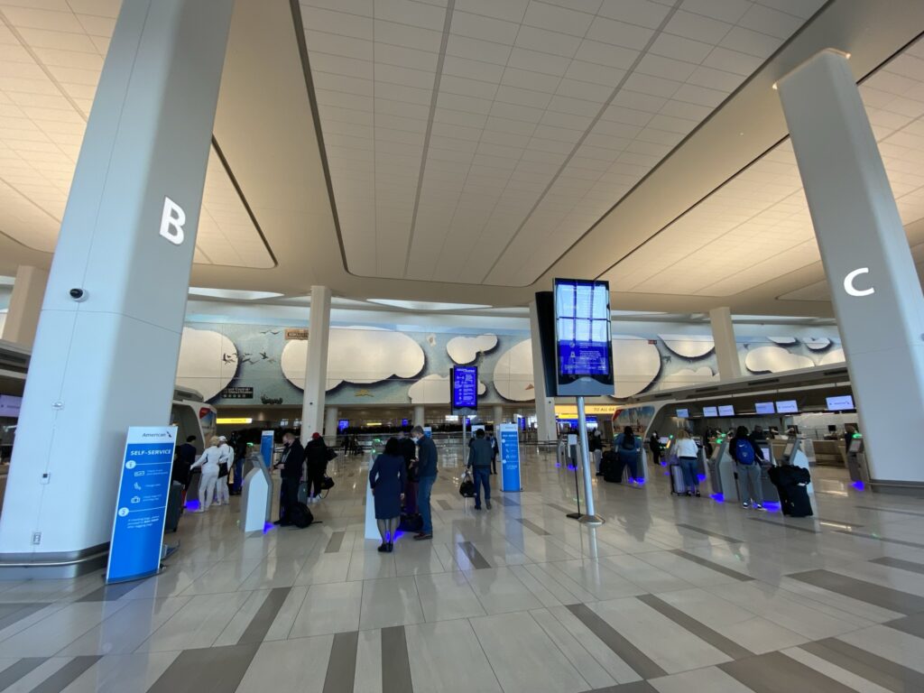 The new LaGuardia Terminal b with people lined up at check ins.