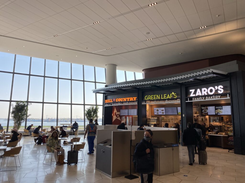 LaGuardia's food court showing the different options and large floor to ceiling windows.