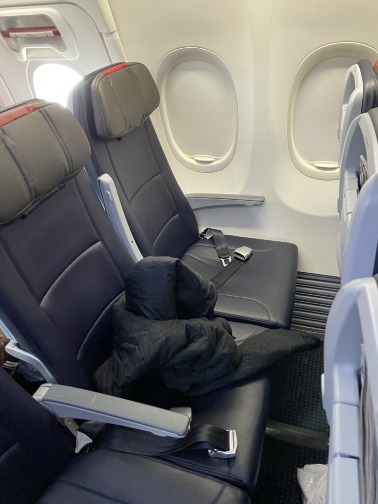 Economy class seat on American Airlines' Boeing 737-800. In greys and blacks.