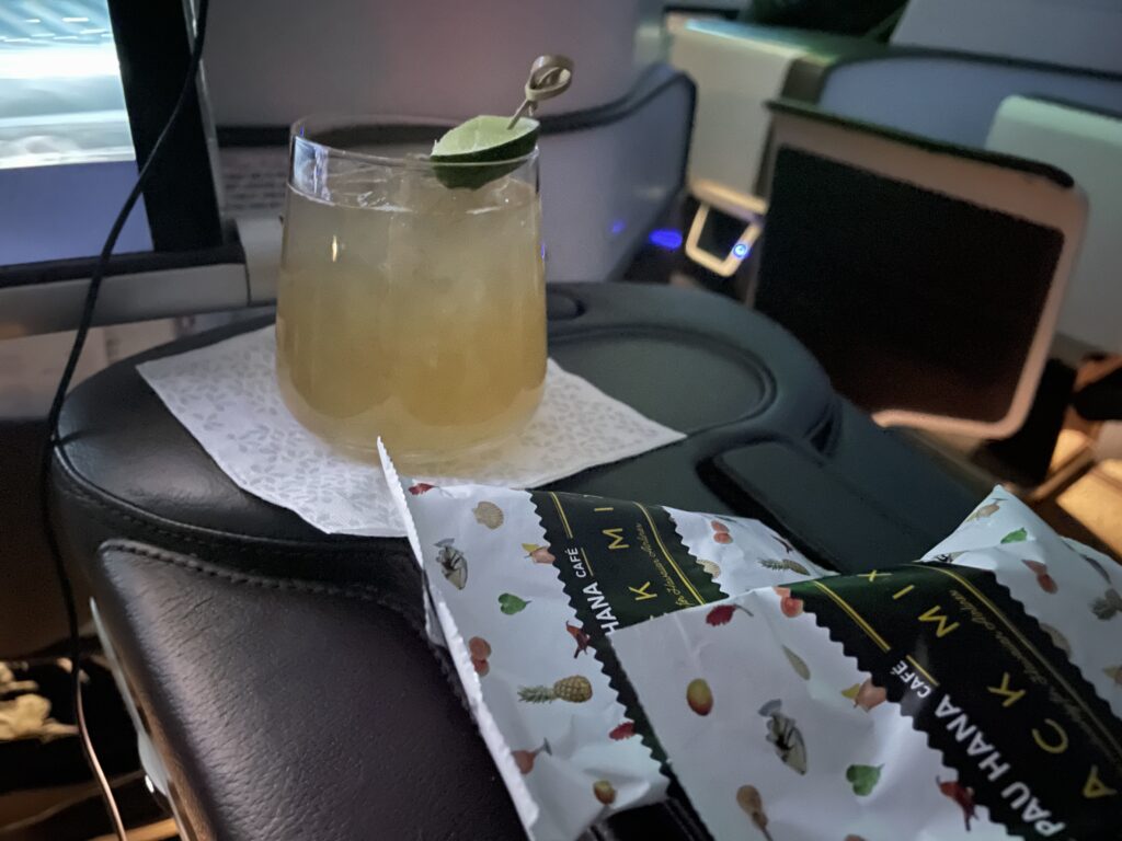 Hawaiian Airlines' Mule with packaged snacks on a aircraft tray table.