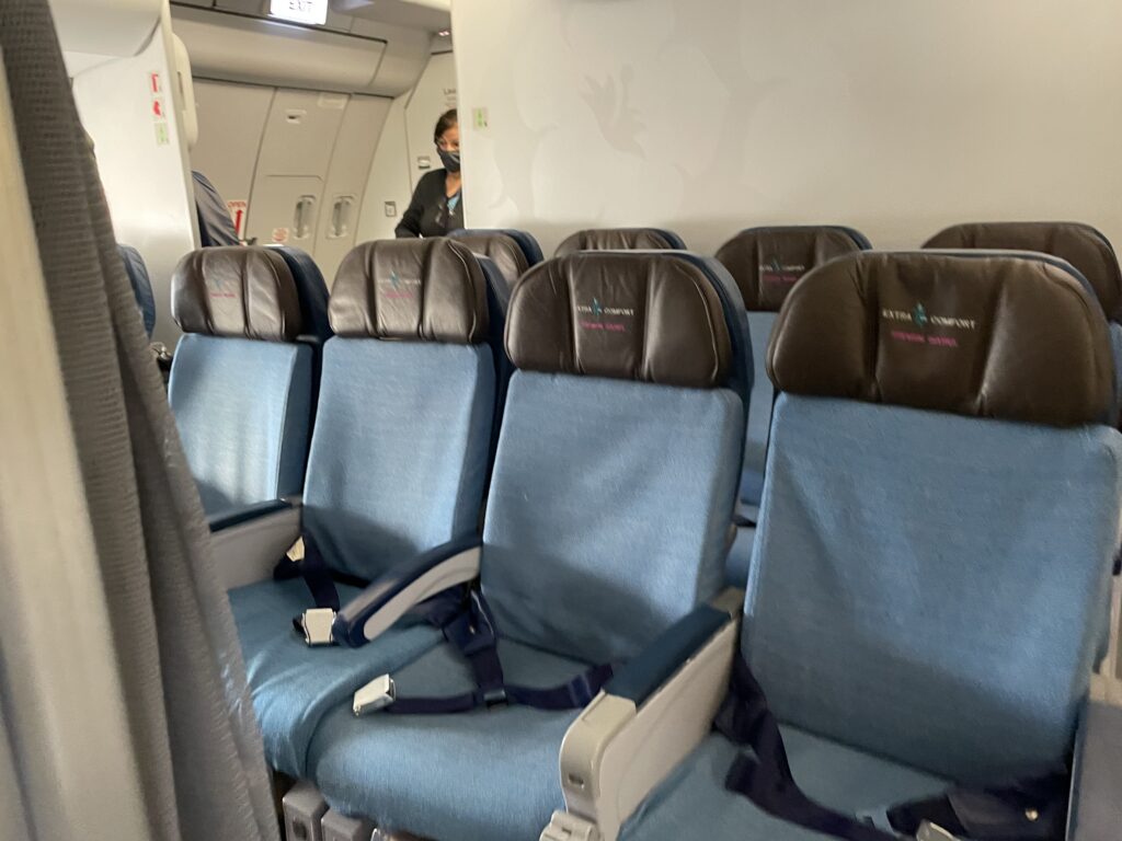 Extra comfort seats on Hawaiian Airlines. Blue with deep brown headrests.