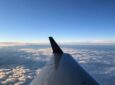 Aircraft flying over Canada, photo shows wing of aircraft through the cabin window