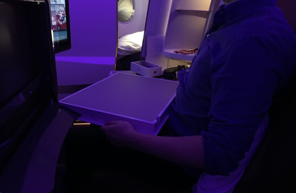 Cirrus NG on Virgin with a passenger demonstrating how the table created very little space to move. 