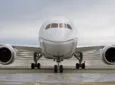 United Airlines Boeing 787 Dreamliner front view of the nose on the runway. Clouds in the sky.