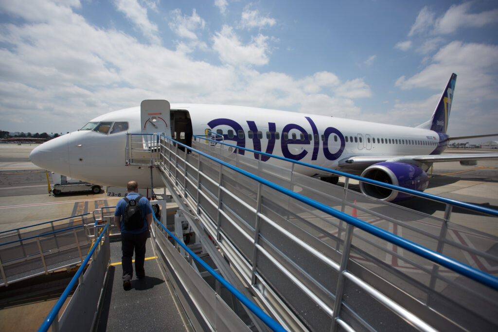 Roll-up ramps set up as passengers walk them to enter the Avelo Aircraft for their flight.