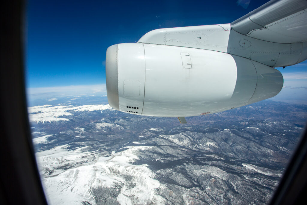 View from the window of Denver Air Connection's Dornier 328JET showing the engine and a mountian view.