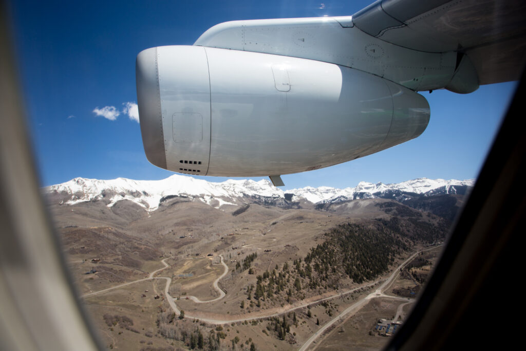 View from the window of Denver Air Connection's Dornier 328JET showing the engine and a mountian view.